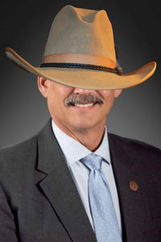 Mark Finchem with a too-large cowboy hat that covers his eyes. 